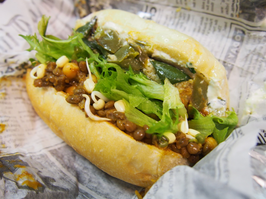 Lentil & chickpea sandwich with sprouted beans, sauteed zucchini and crisp lettuce in Tallinn, Estonia