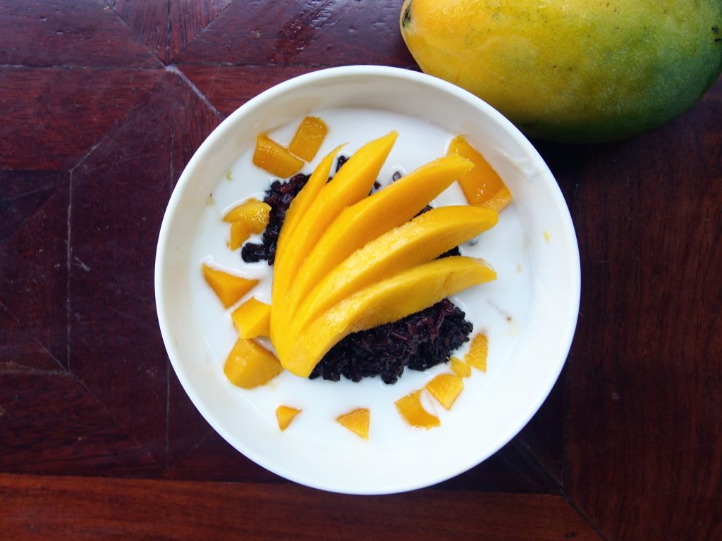 Coconut milk over black sticky rice with Mango